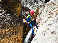 Kid abseiling in a canyon of Guara